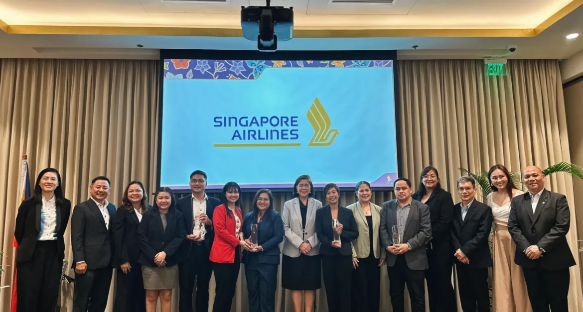Airtropolis Consolidator Phils., Inc. representatives at the Singapore Airlines awarding event with airline branding in the background