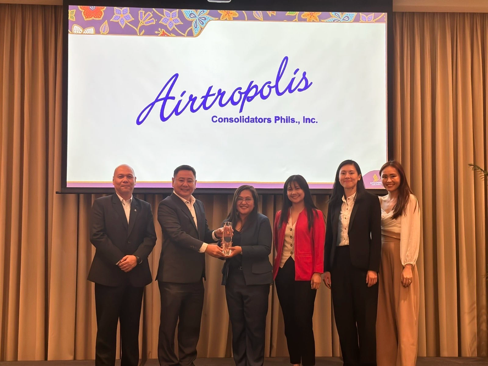 Airtropolis Consolidator Phils., Inc. management team receiving recognition at the Singapore Airlines awarding event in Parañaque City